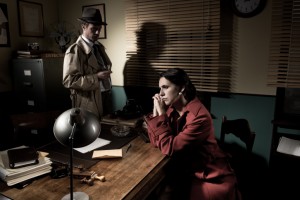 Detective interviewing a young sad woman in his office, film noir scene.