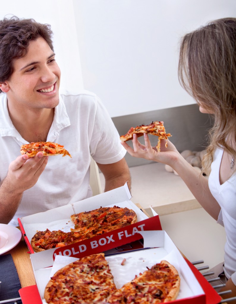Young couple eating pizza