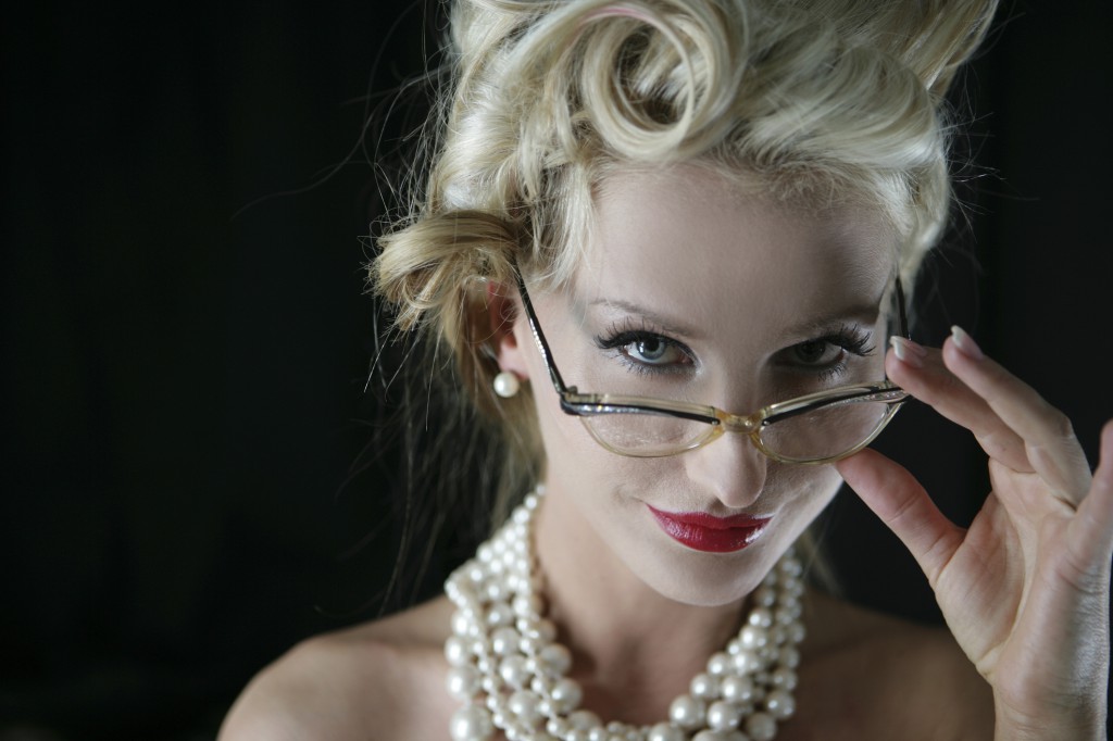 Portrait of sexy blonde woman in eyeglasses and pearl necklaces