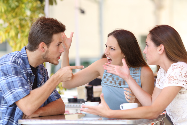 Angry friends arguing in a coffee shop