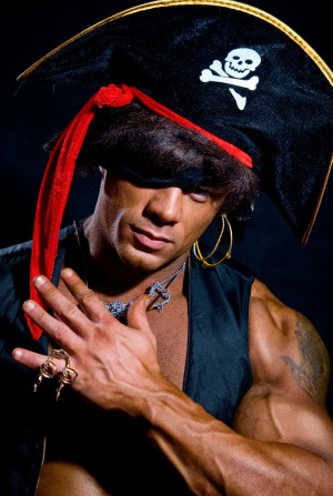 Close-up portrait muscular pirate in the studio on a dark background