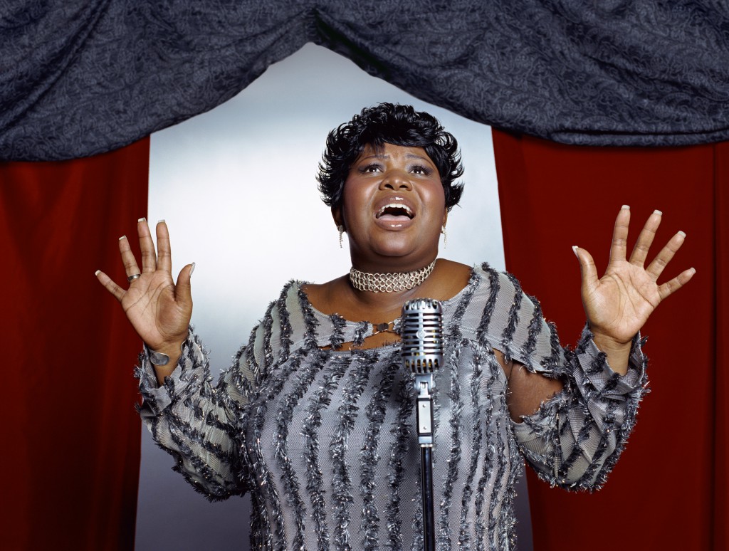 Plus-sized woman singing with microphone