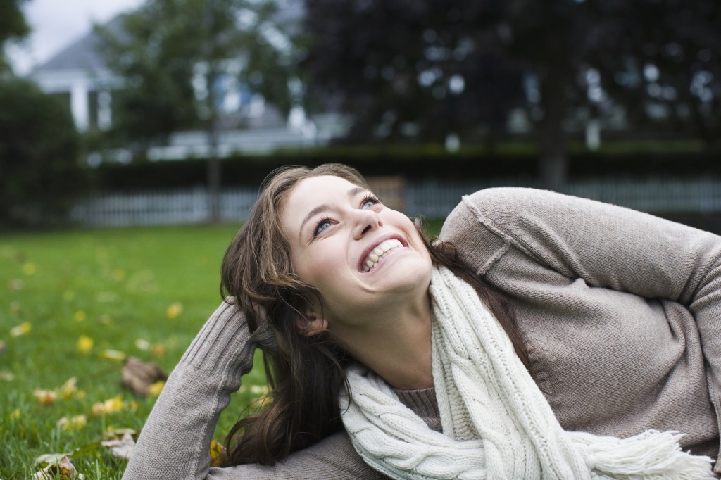 Woman day dreaming in a park